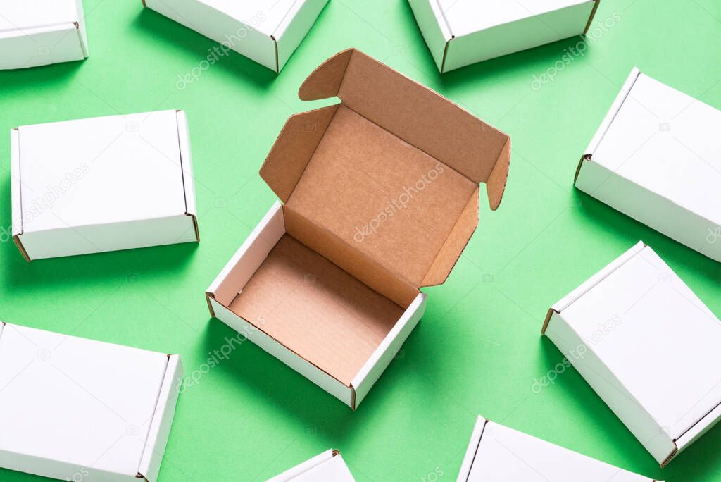 Lot of square carton boxes on green background