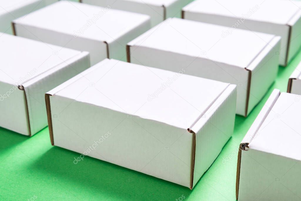 Lot of square carton boxes on green background