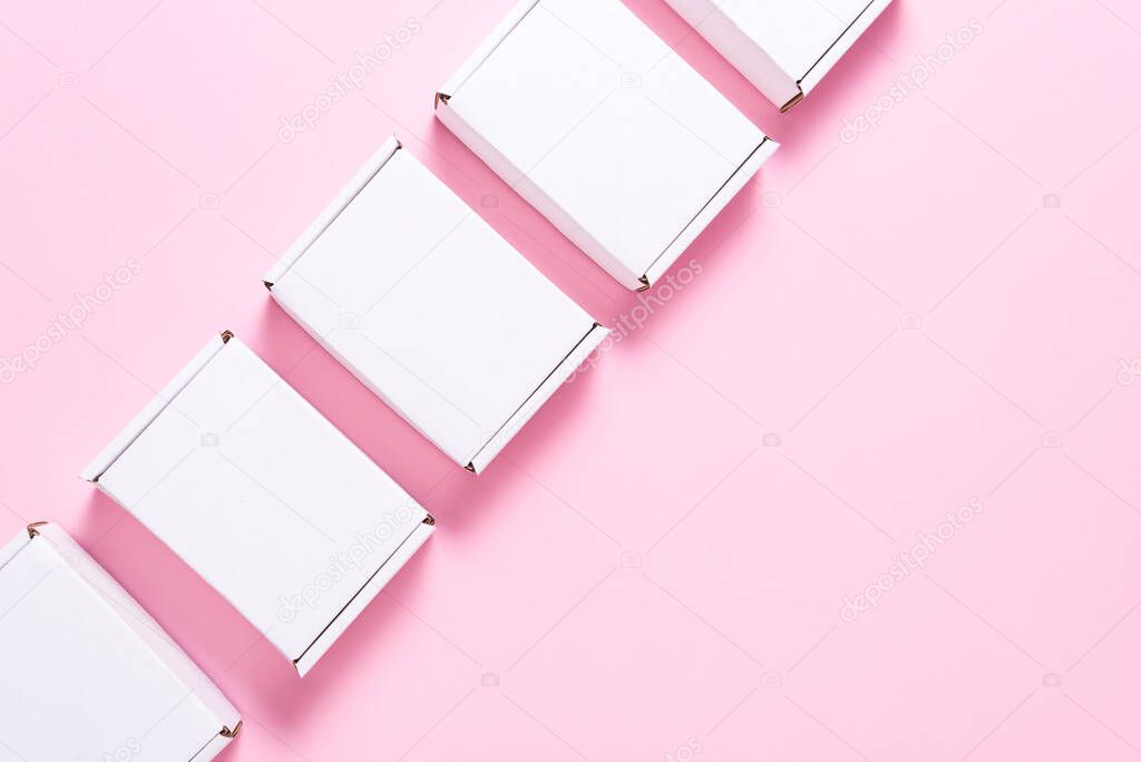 Lot of square carton boxes on pink background