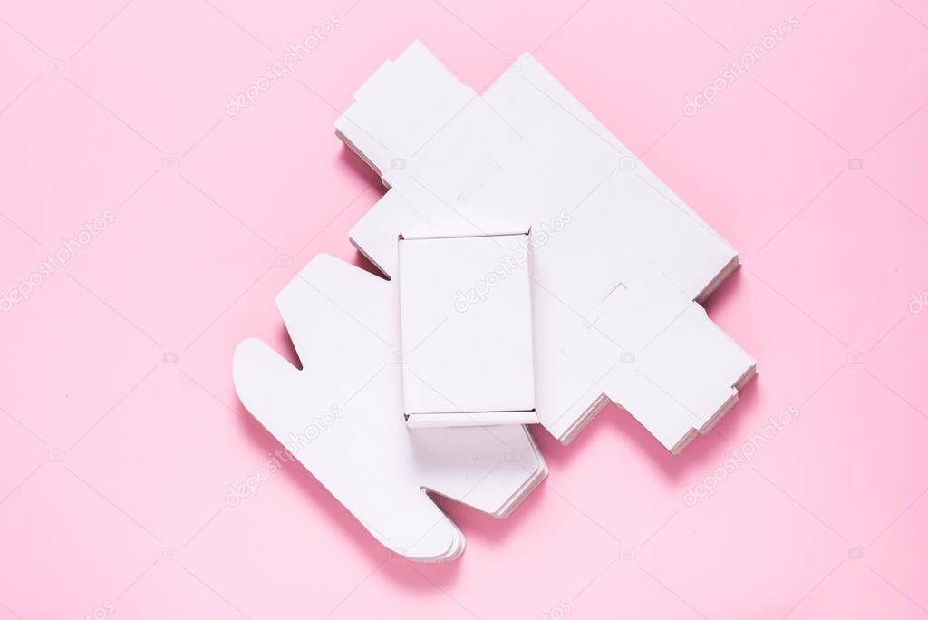 Lot of square carton boxes on pink background, cutted