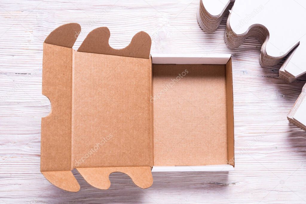Lot of square carton boxes on wooden background, cutted