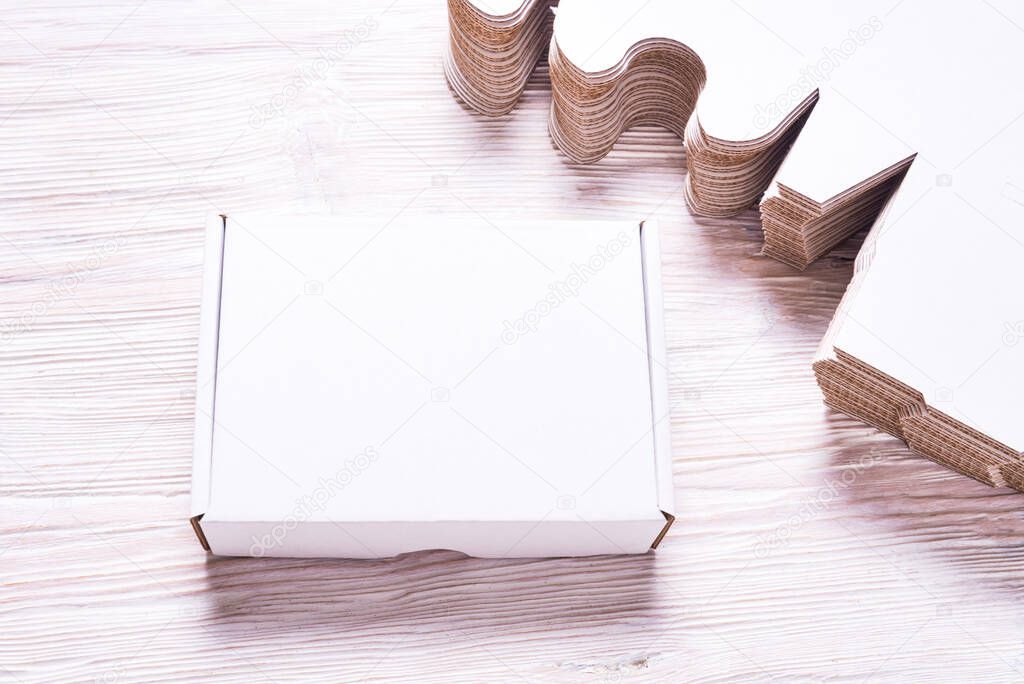 Lot of square carton boxes on wooden background, cutted