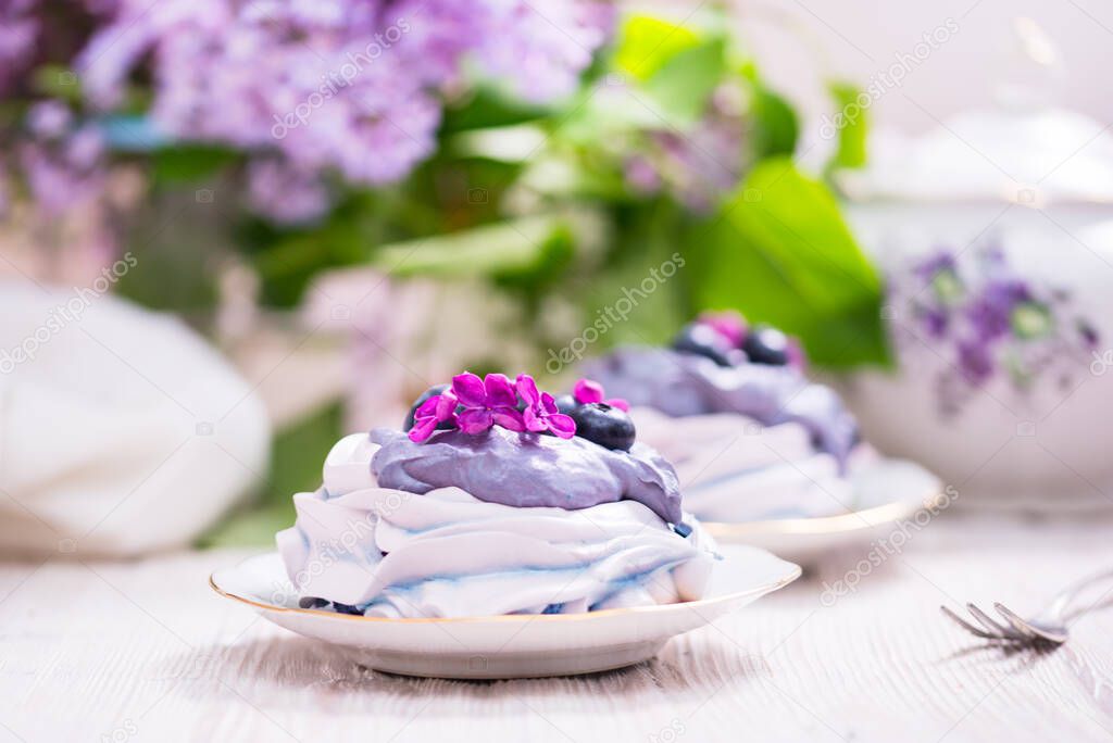 Porcelain plate with meringue with whipped cream decorated with 