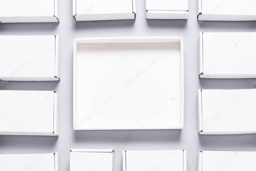 Lot of square carton boxes on grey background