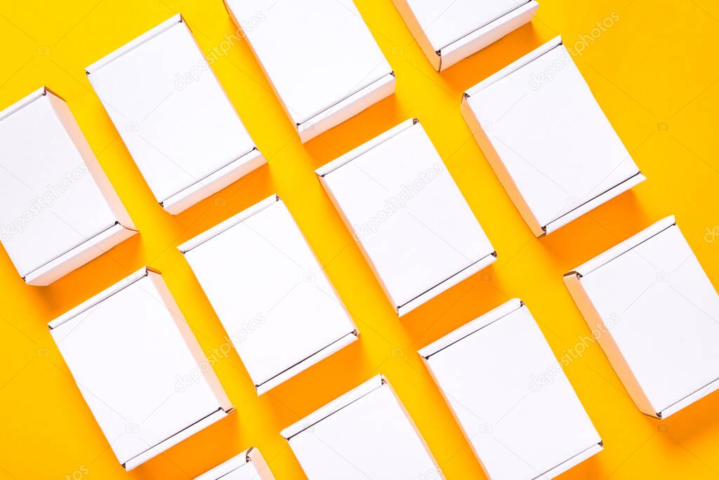 Lot of square carton boxes on yellow background