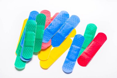 Beyaz arkaplanda renkli ilk yardım alçıları