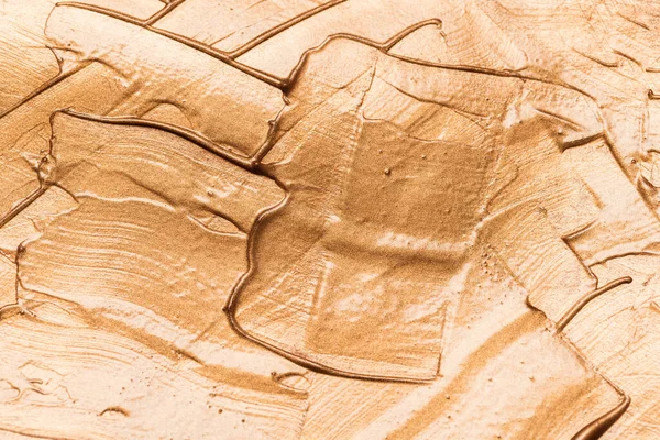 Metallic glosary brown makeup smears of creamy foundation textur