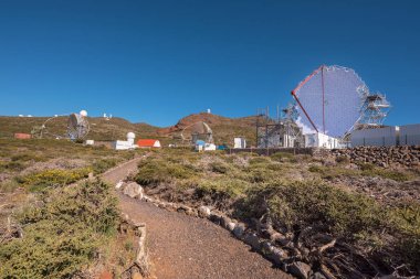 La Palma, Spain - May 30, 2018: Magic Gamma ray telescope in ORM observatory of Roque de los muchachos, Canary islands, Spain. clipart