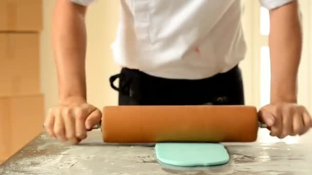 Konditorn med brödkavel förbereder fondant kaka utsmyckning. — Stockvideo
