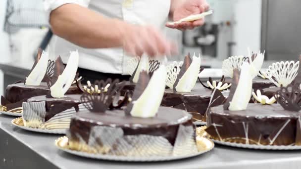 Pastry Chef Decorating Several Cakes In The Kitchen Of The Pastry