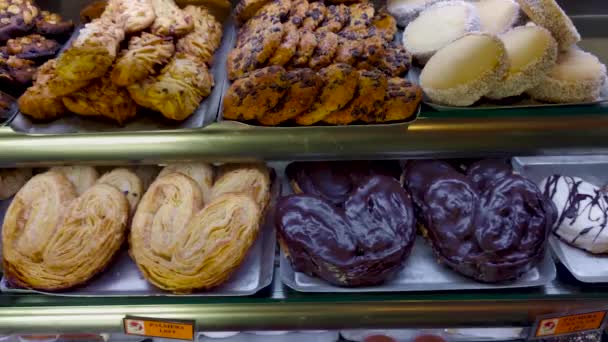 Tenerife, Espanha - Por volta de janeiro de 2019: Mostra com bolos em exposição na pastelaria e padaria. Fecha a porta. 4K . — Vídeo de Stock