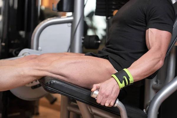 Handsome strong man performed leg press workout in the gym. — Stock Photo, Image