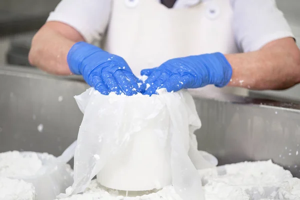 Working woman preparing cheese raw dough into molds — Stock Photo, Image