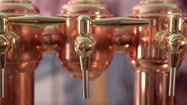 Dolly shot, of shiny beer tap ready to serve cold beer at the bar. — Stock Video