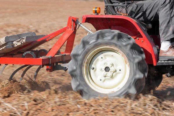 Red Tractor With Plough Plowing Field Soil Close Up View. — Stock Photo, Image