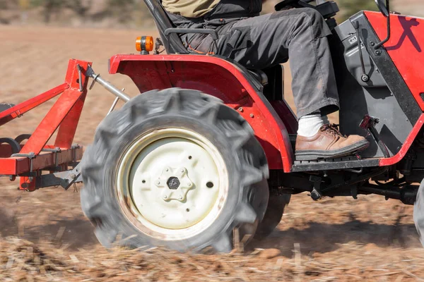 Red Tractor With Plough Plowing Field Soil Close Up View. — ストック写真