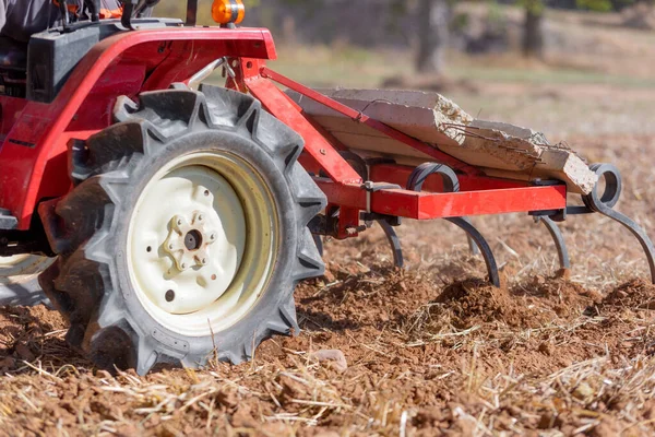 Red Tractor With Plough Plowing Field Soil Close Up View. — ストック写真