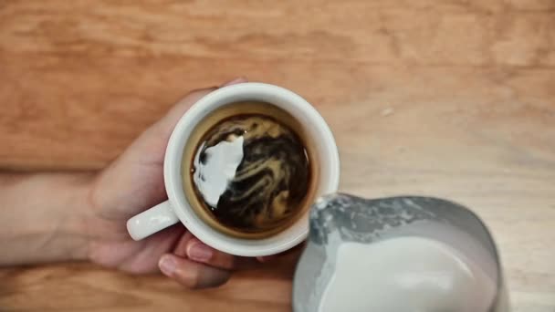 ภาพระยะใกล้ของบาริสต้าแสดงให้เห็นถึงศิลปะของการเทและเตรียมถ้วยกาแฟ การทําศิลปะลาเต้ . — วีดีโอสต็อก