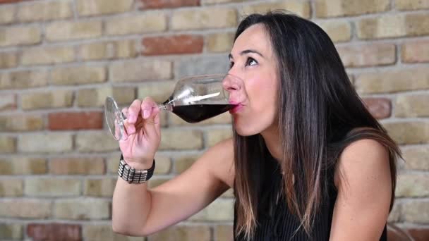 Красивая женщина наслаждается ужином с друзьями, пьет красное вино в ресторане. — стоковое видео