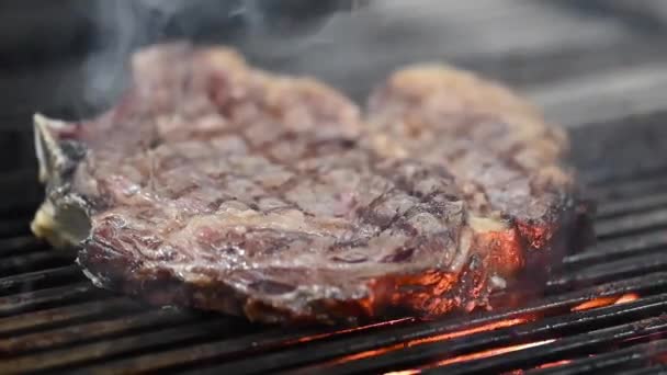 Close up of delicious beef steak on flaming grill. — Stock video