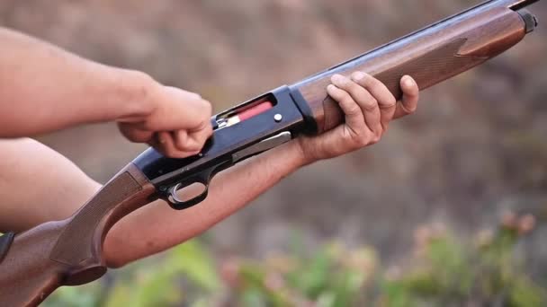 Close up of a hunter hands unloading a shotgun. Slow motion. — Stock Video