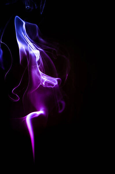 Colorful trickle of smoke on a dark background