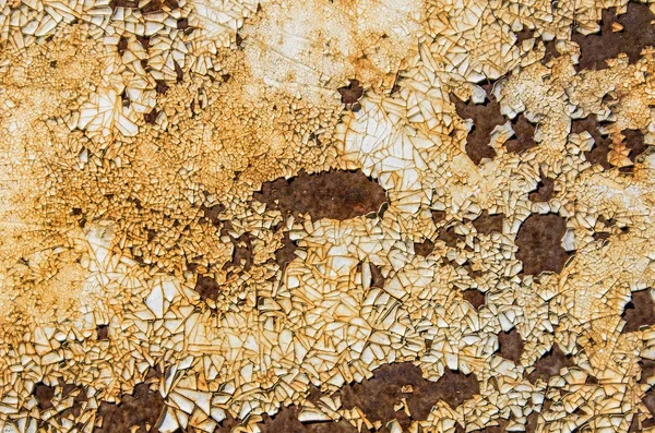 Rust and white paint residue on metal surface