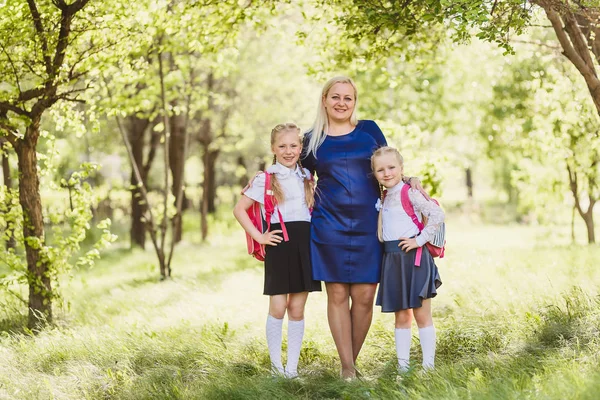 Gelukkige Vrouw Hugs Kinderen School Uniform Buitenshuis — Stockfoto