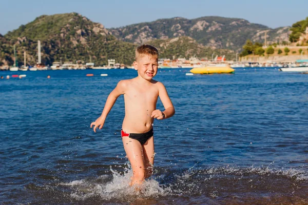 six-year-old boy having fun in the summer at the sea