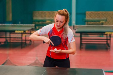 young woman does lodge in table tennis, Caucasian woman in a professional uniform plays table tennis clipart