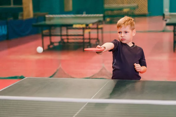 table tennis party, Caucasian boy beats the ball in table tennis