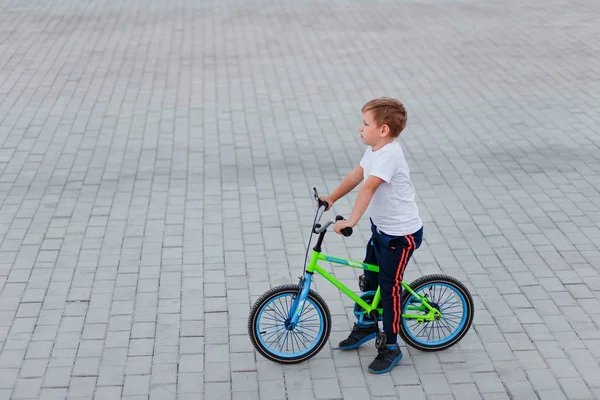 Seven Year Old Boy White Shirt Sits Bicycle Gray Paving — Stock Photo, Image