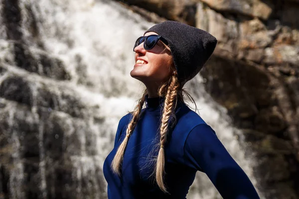 Leende kvinna nära vattenfallet — Stockfoto