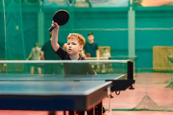 the child plays table tennis training