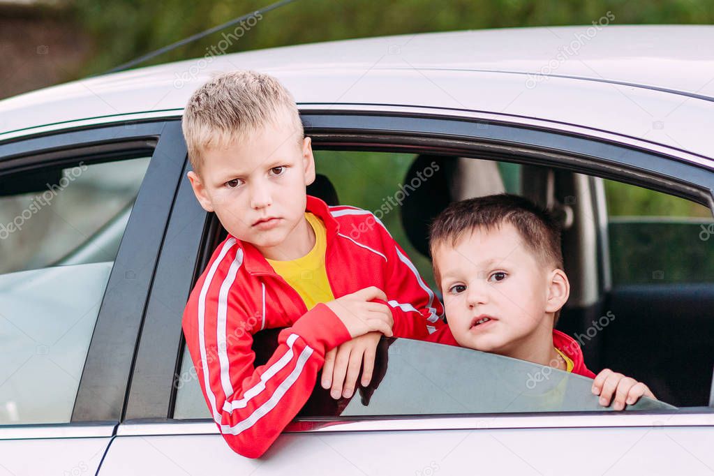 Kids look at you from the car window