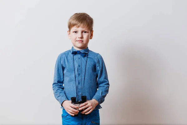 Menino com binóculos em um fundo branco — Fotografia de Stock