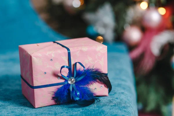 Beautiful Christmas box with blue ribbon. gift on a blury Christmas background