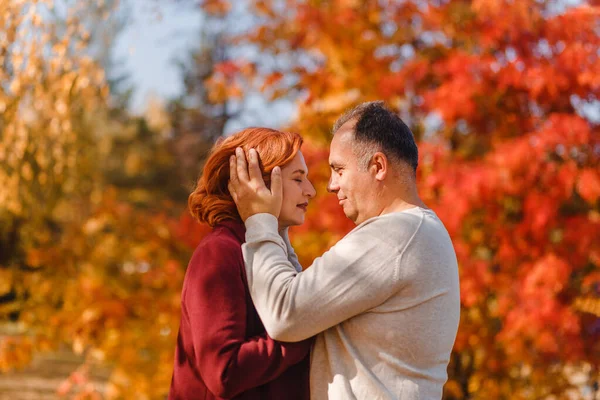 Gray Haired Middle Aged Man Cuddles Red Haired Woman Fall — Stock Photo, Image