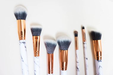 Beyaz arkaplandaki mermer izlerinin makyajı için fırçalar