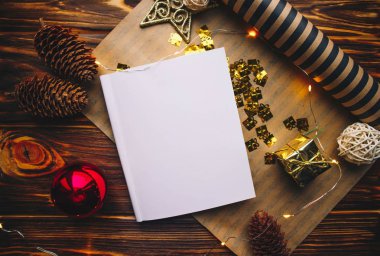 Yılbaşı arkaplanında kağıt ve noel süslemeleri olan temiz kart