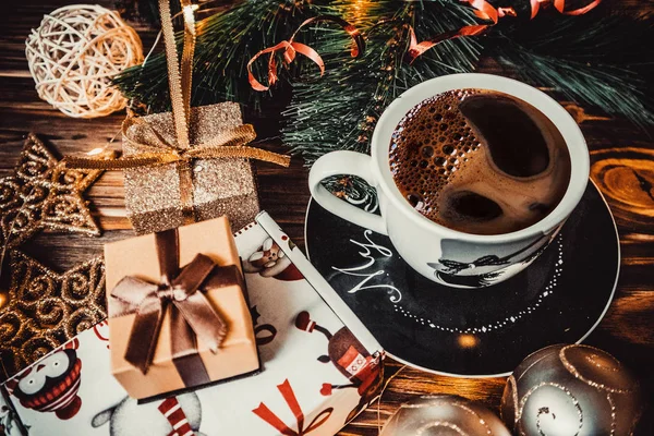 Coffee and new year toys on a wooden background