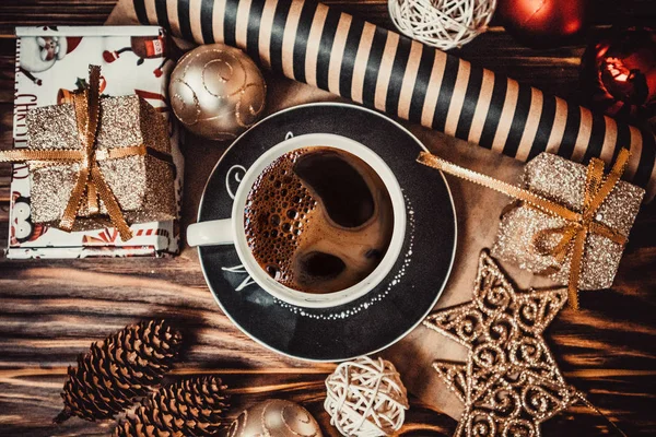 Coffee and new year toys on a wooden background