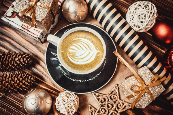 Coffee and new year toys on a wooden background