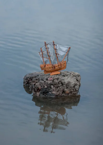 Una pequeña maqueta de un barco en el agua — Foto de Stock