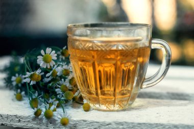 Ahşap arka planda papatya çayı..