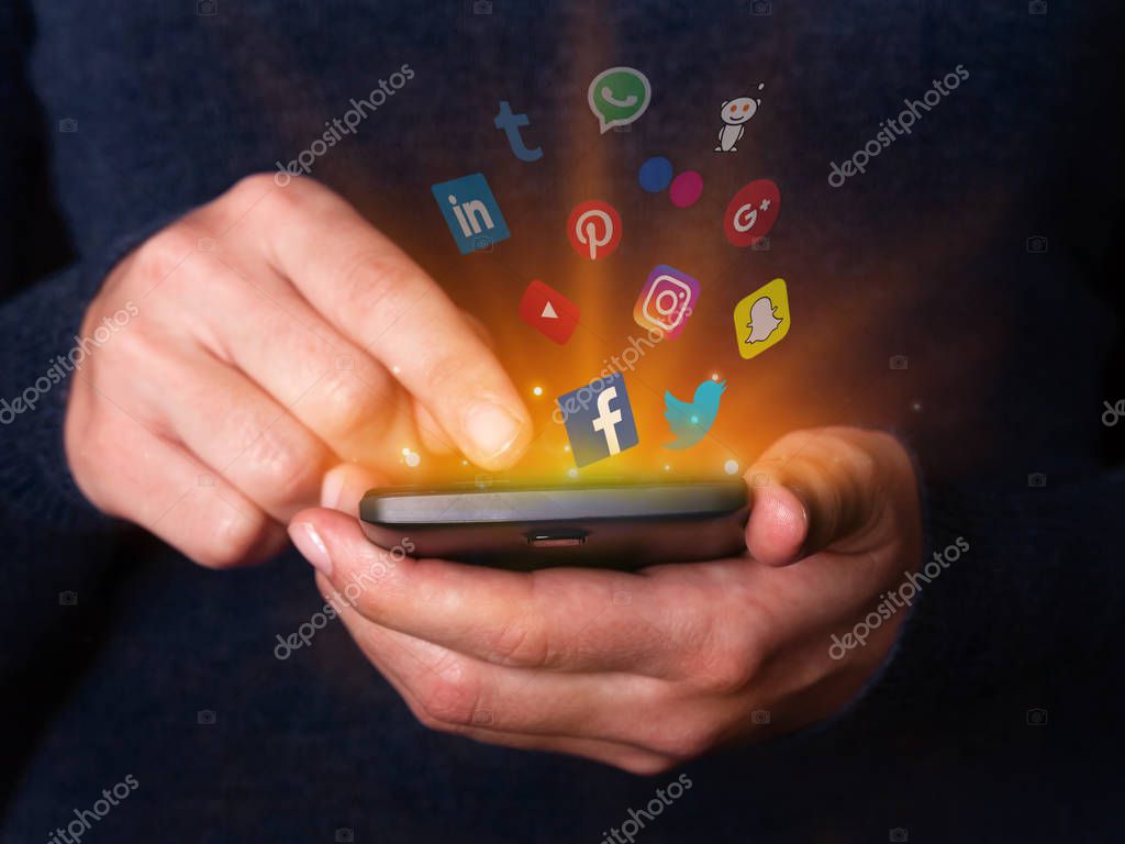 Lisbon, Portugal - December 2, 2017: Woman hands holding and using smartphone mobile phone checking social media networks apps. Facebook twitter youtube instagram snapchat google plus pinterest logos