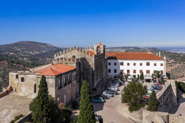 Palmela, Portugal - August, 2015: Capelo House, the Historical Hotel and Santiago Church, inside the Palmela Castle. clipart