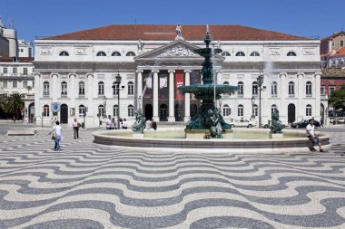 Lisbon, Portugal - April 26, 2013: Dona Maria II National Theatre and fountain in Rossio (Dom Pedro IV) Square, the main square of Lisbon. clipart