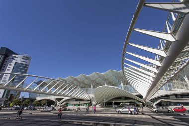Lisbon, Portugal - August 02, 2013: Commuters go in and out of the Gare do Oriente (Orient Station), a public transport hub designed by the famous architect Santiago Calatrava. clipart
