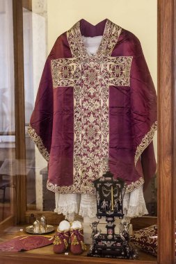 Mafra, Portugal - September 02, 2013: Clergy vestments - Chasuble, Rochet and Maniple. Mafra National Palace, Portugal. clipart
